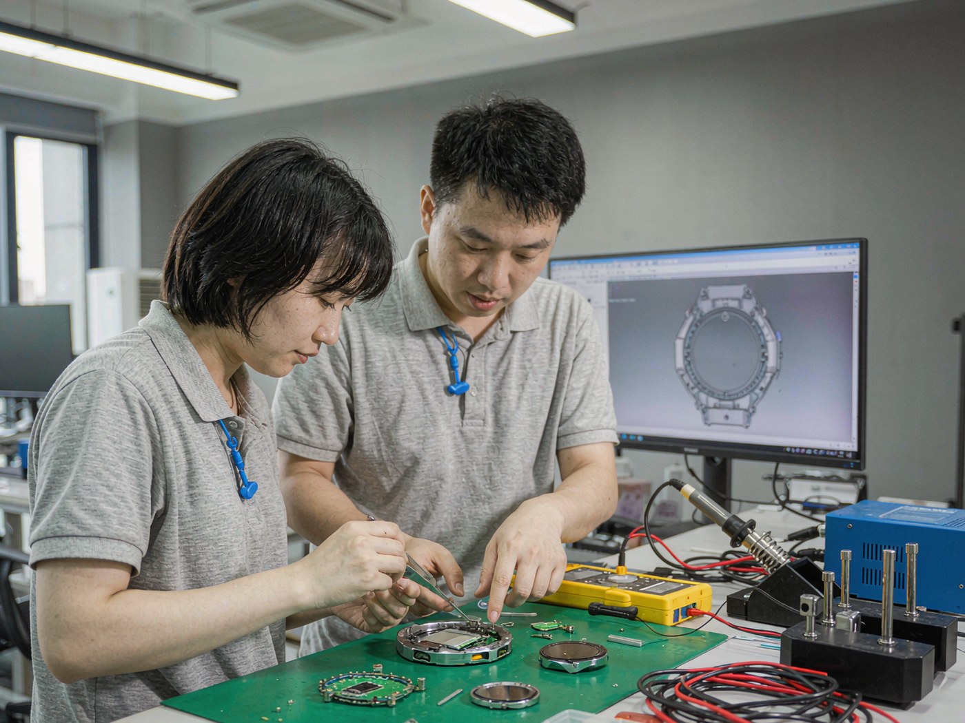 Aiullain R and D engineers assembling and testing a smart watch prototype
